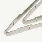 A modern, white and grey abstract sculpture with geometric shapes and sharp angles.