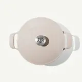 A round, light-colored cooking pot features a metal lid with the Texas A&M logo prominently displayed on top.