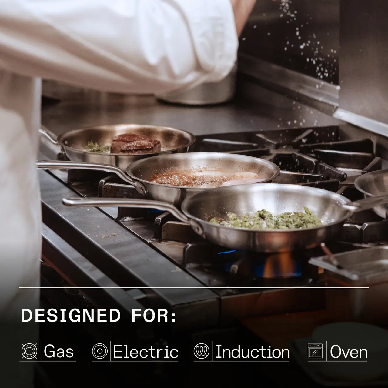 A chef is cooking various dishes in multiple pans on a professional stovetop, with a splash of seasoning falling into one of the pans.