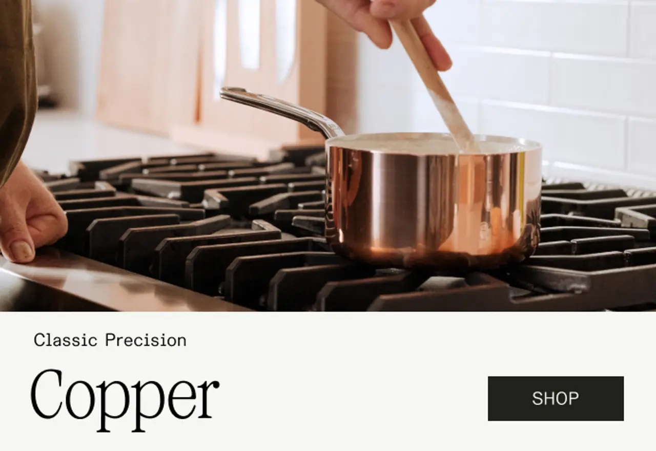 A hand stirs a pot on a gas stovetop, accompanied by promotional text for copper cookware.