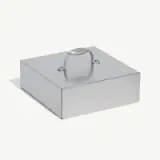 A rectangular metal box with a handle on top is displayed against a plain background.