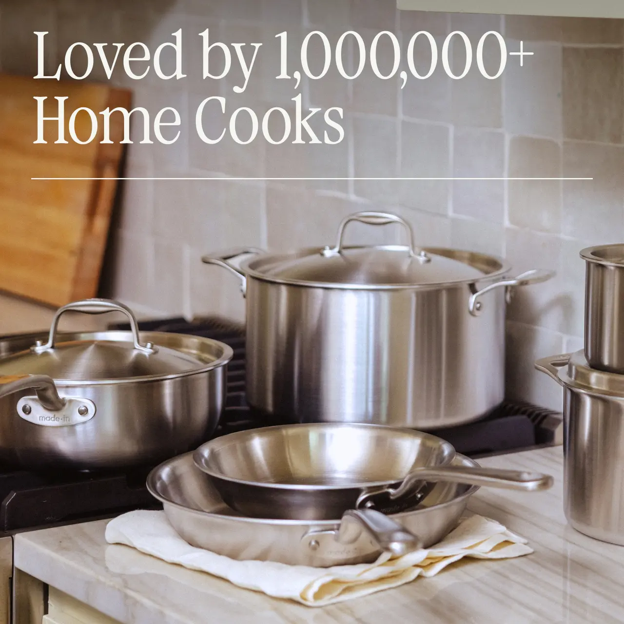 A collection of stainless steel cookware sits on a stovetop, highlighting its popularity among home cooks.