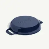 A round, navy blue cast iron cooking vessel with two side handles and a smooth, glossy finish.