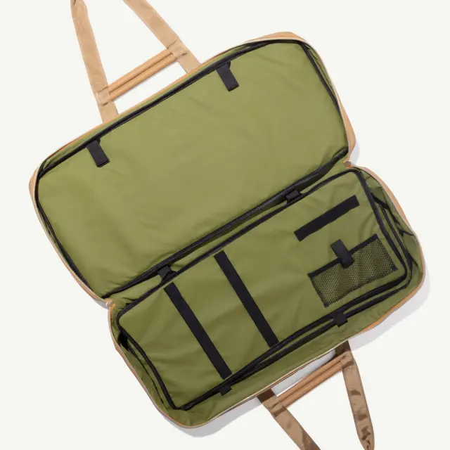 A spacious green duffel bag with a tan trim, featuring multiple interior compartments and straps for easy carrying.