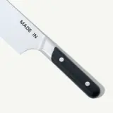 A stainless steel knife with a black handle is shown, featuring "MADE IN" printed on the blade.