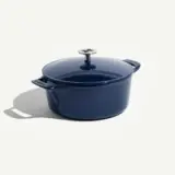 A deep blue enameled cast iron pot with a matching lid and metal handle.