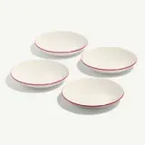 Four white bowls with red rims are arranged in a staggered pattern.