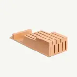Wooden knife block with multiple slots for storing different sizes of knives.