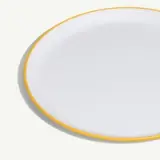 A round white plate with a simple yellow rim.