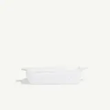 A white rectangular ceramic baking dish with two handles and a dotted pattern is centered on a plain white background.