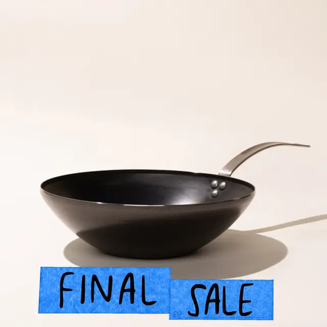 A black wok with a handle is displayed with a tag below it that reads "FINAL SALE" on a neutral background.
