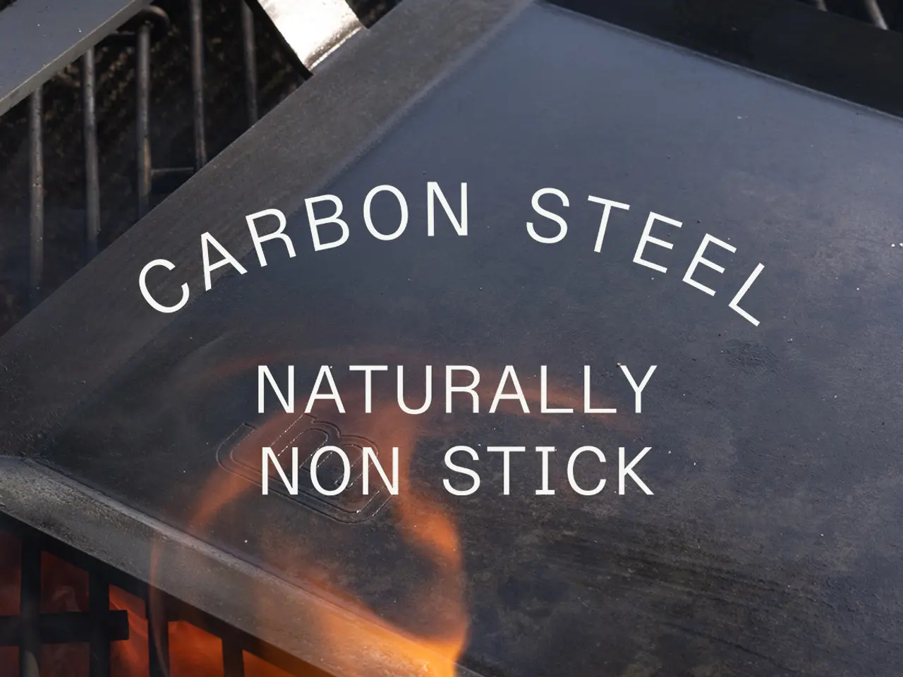 Close-up view of a label on a cookware item that reads "CARBON STEEL NATURALLY NON STICK," highlighting its material and feature.