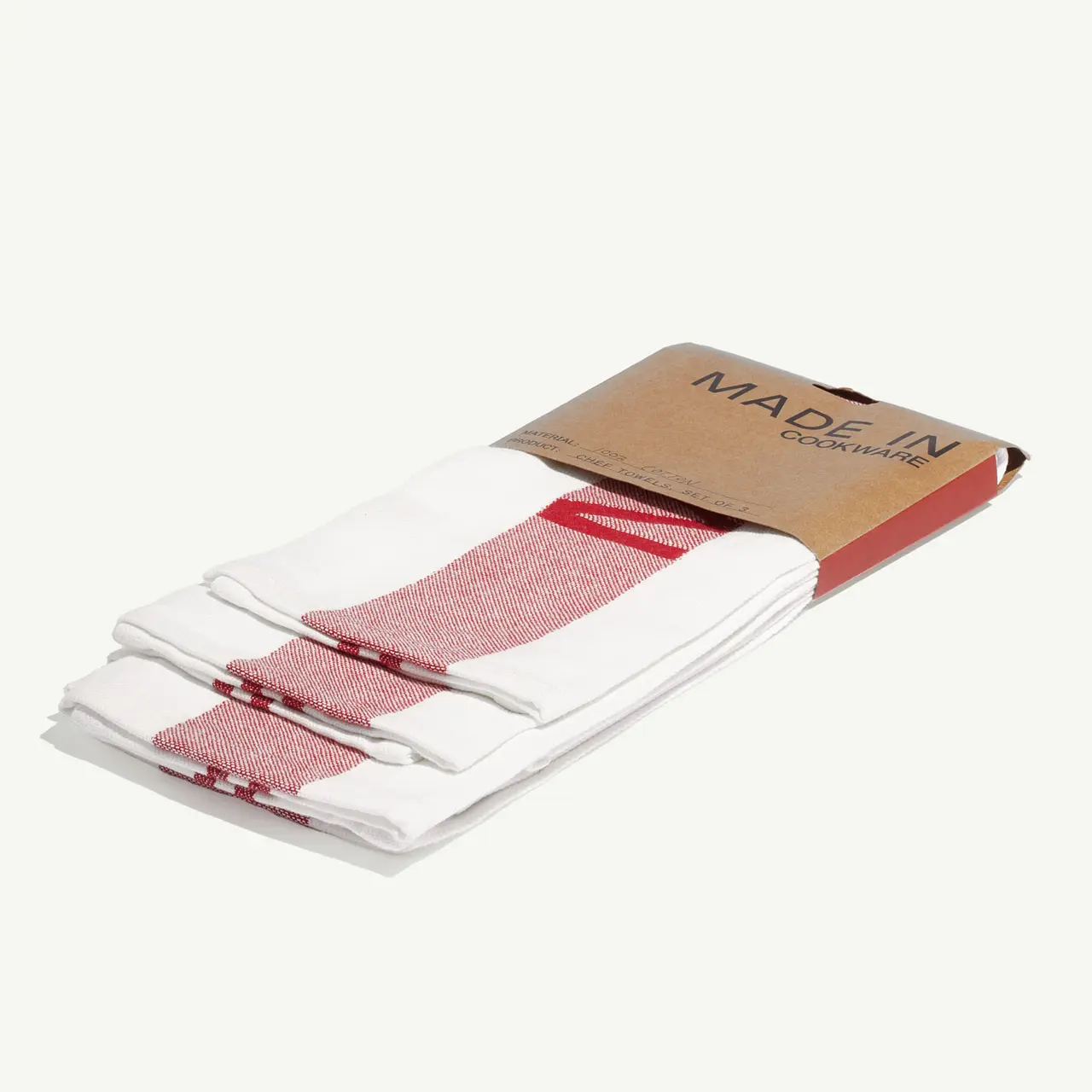 A pack of white and red striped kitchen towels labeled "MADE IN" on a light background.