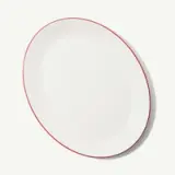 White oval plate with a thin red rim.