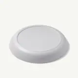A plain white disc with a slightly raised edge and a smooth surface.