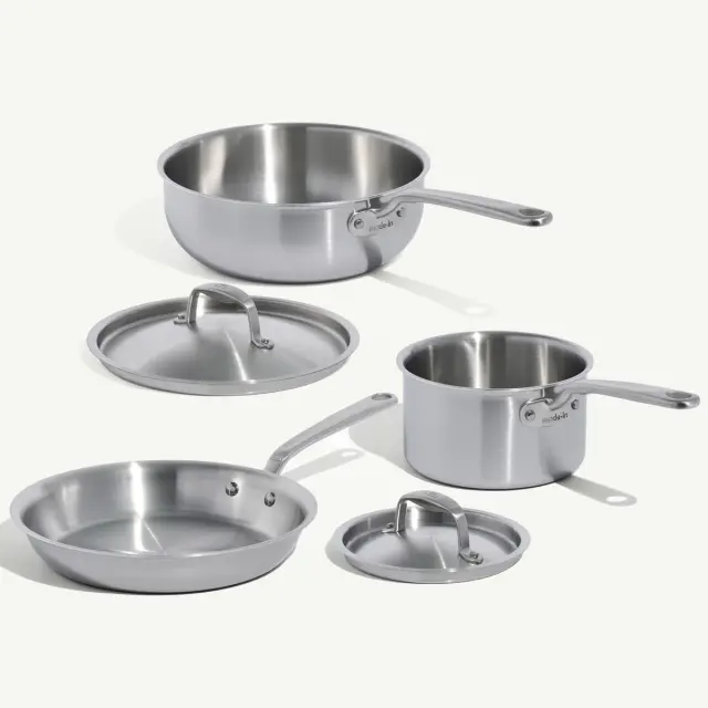 A set of stainless steel cookware, including a saucepan, a sauté pan, and their respective lids.