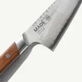 A high-quality Japanese chef's knife featuring a stainless steel blade with a wooden handle and engraved markings.
