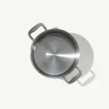 A stainless steel pot with two handles is shown from a top-down view against a plain background.