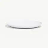 A plain white plate sits on a light background, casting a subtle shadow.