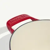 A close-up view shows the handle of a red cookware pot with "Made In" embossed on it.
