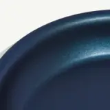 Close-up view of a dark blue round pan with a smooth, matte finish.