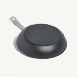 A black, non-stick frying pan with a silver handle is shown from the bottom.
