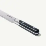 A stainless steel knife with a black handle featuring the inscription "made-in."