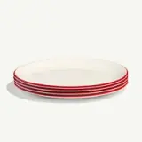 A stack of five white plates featuring a red rim.
