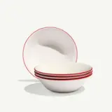 Five nested white bowls with red rims are arranged in front of one upright bowl.