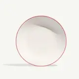 A white plate with a thin red rim is shown against a plain background.