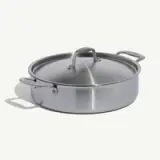 A stainless steel cooking pot with a matching lid and handles on a light background.
