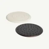 Two round coasters, one white and one black with holes, are placed on a plain background.