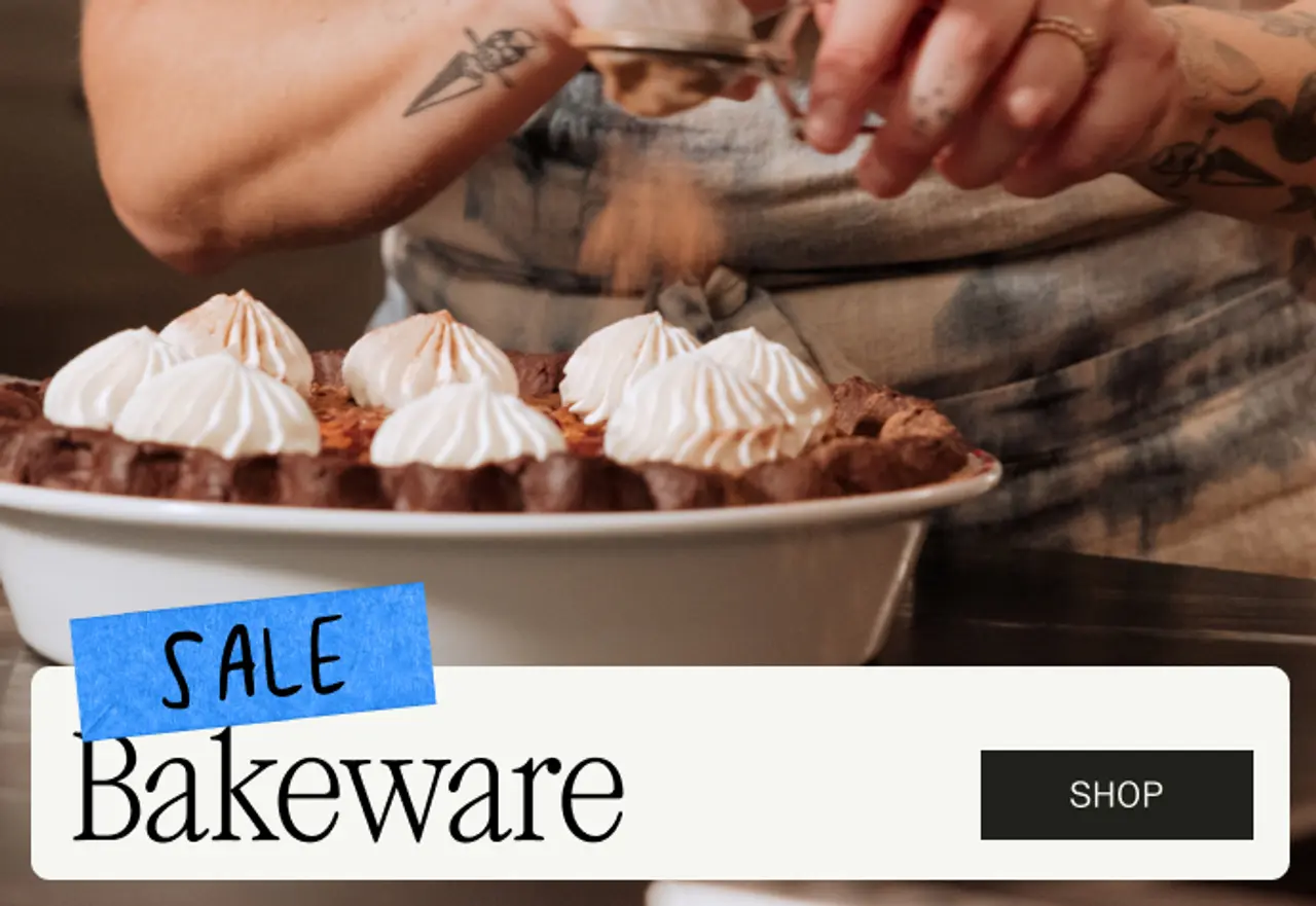 A person sprinkles a topping on meringue-topped dessert in front of promotional text for bakeware sale.