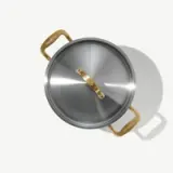 A stainless steel pot with a shiny lid and golden handles sits on a light background.
