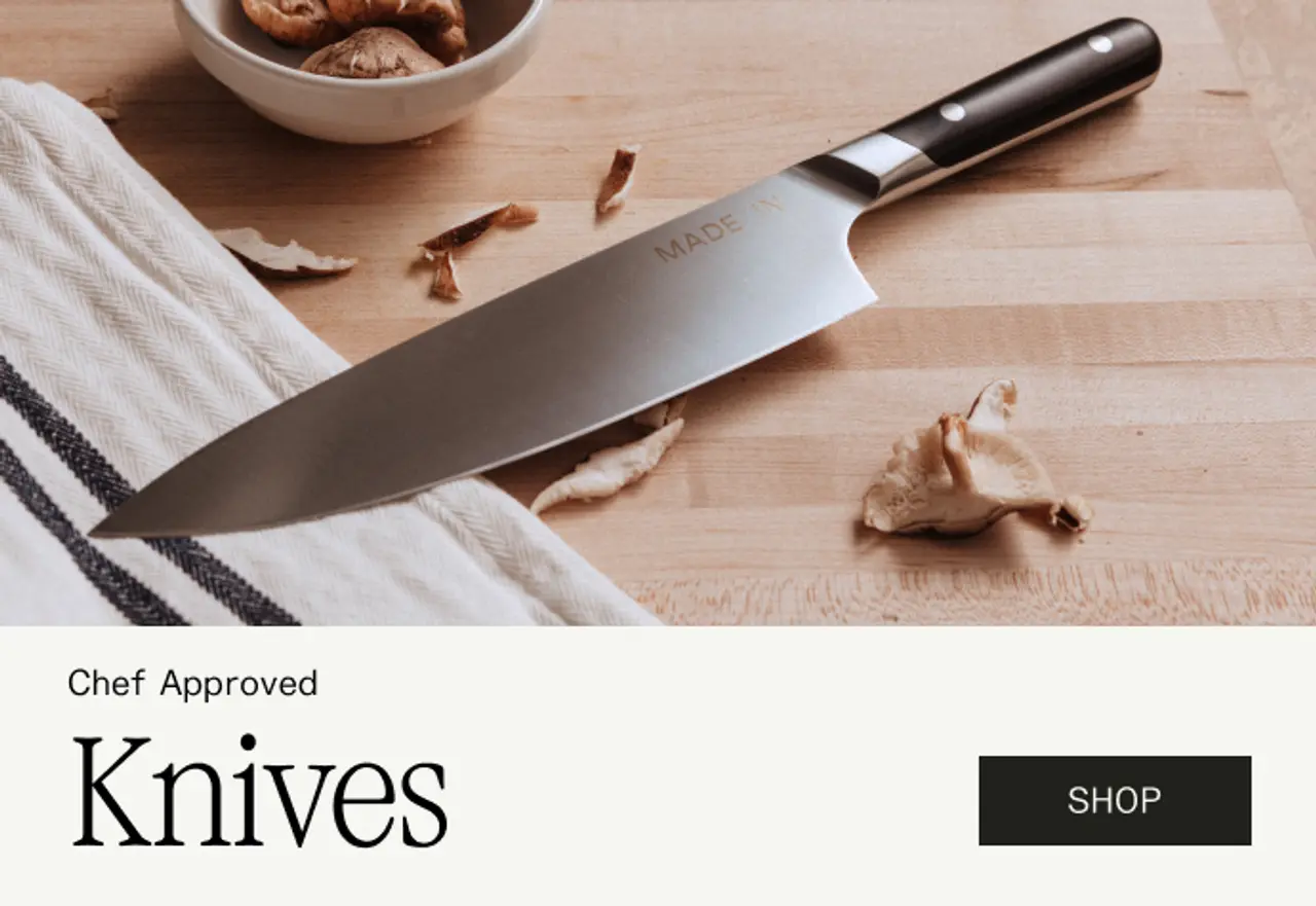 A chef's knife rests on a wooden cutting board alongside dried mushrooms and a bowl of nuts, with promotional text for "Chef Approved Knives" and a "Shop" button.