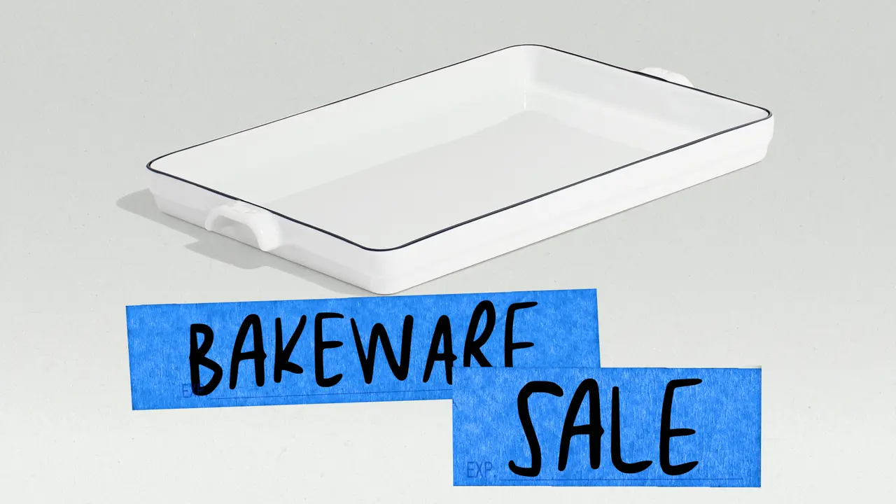 A white baking dish with a blue rim is displayed alongside handwritten blue signs promoting a bakeware sale.