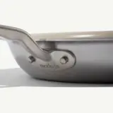 A stainless steel frying pan with a sleek handle and the brand "made-in" engraved on the side.