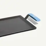 A rectangular non-stick griddle with a blue handle is shown on a light background.