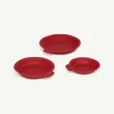Three red, silicone, round baking pans in different sizes arranged against a white background.
