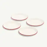 Four white plates with red rims are arranged in a staggered formation on a light background.