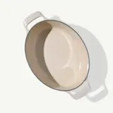 Top-down view of a beige ceramic casserole dish with handles on both sides.