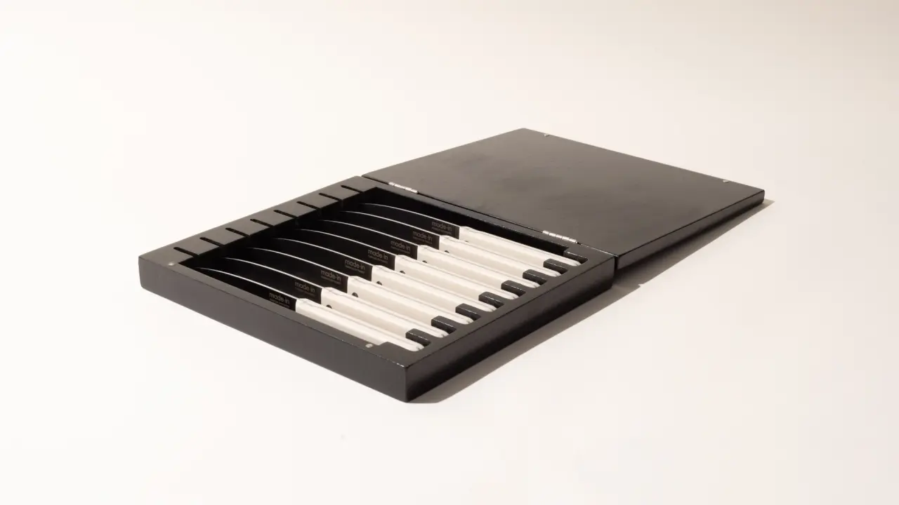 A portable USB MIDI keyboard with black and white keys is displayed against a plain background.