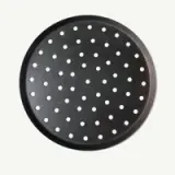 A round, perforated baking tray with a black finish, featuring evenly spaced holes.