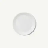 A round, plain white plate is centered against a light background.