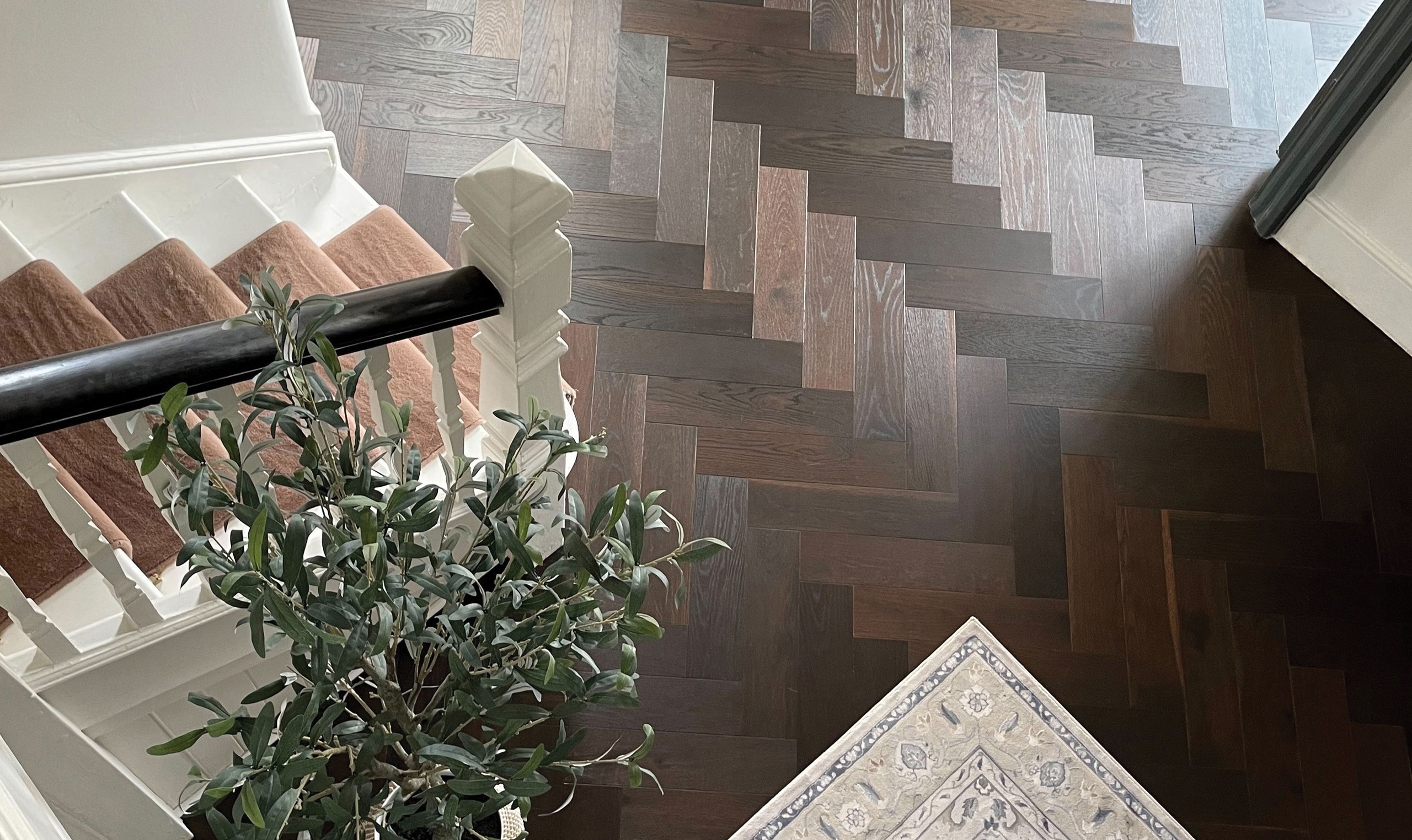 Hallway with layered Ted Todd wood flooring