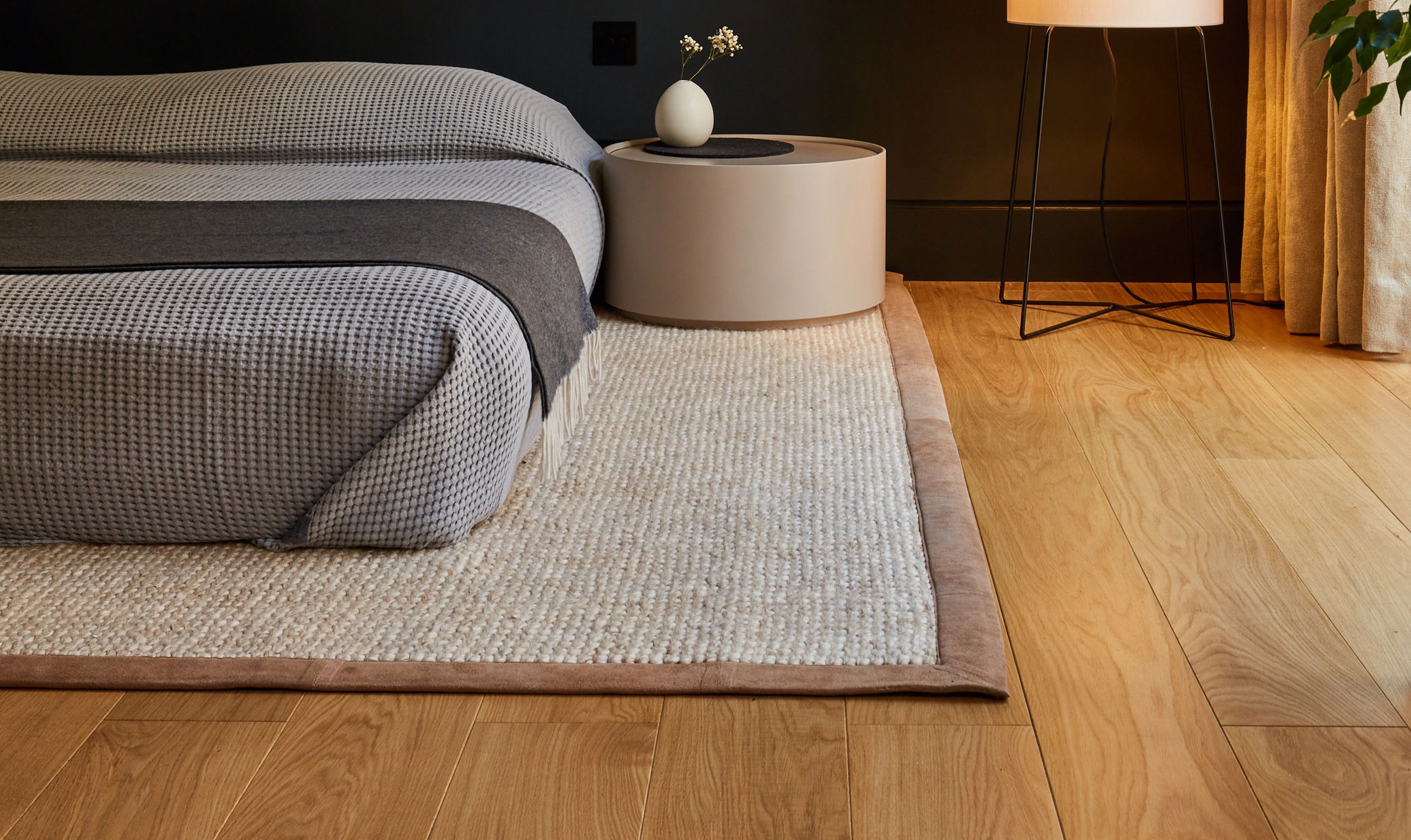 Bedroom with layered Ted Todd wood flooring