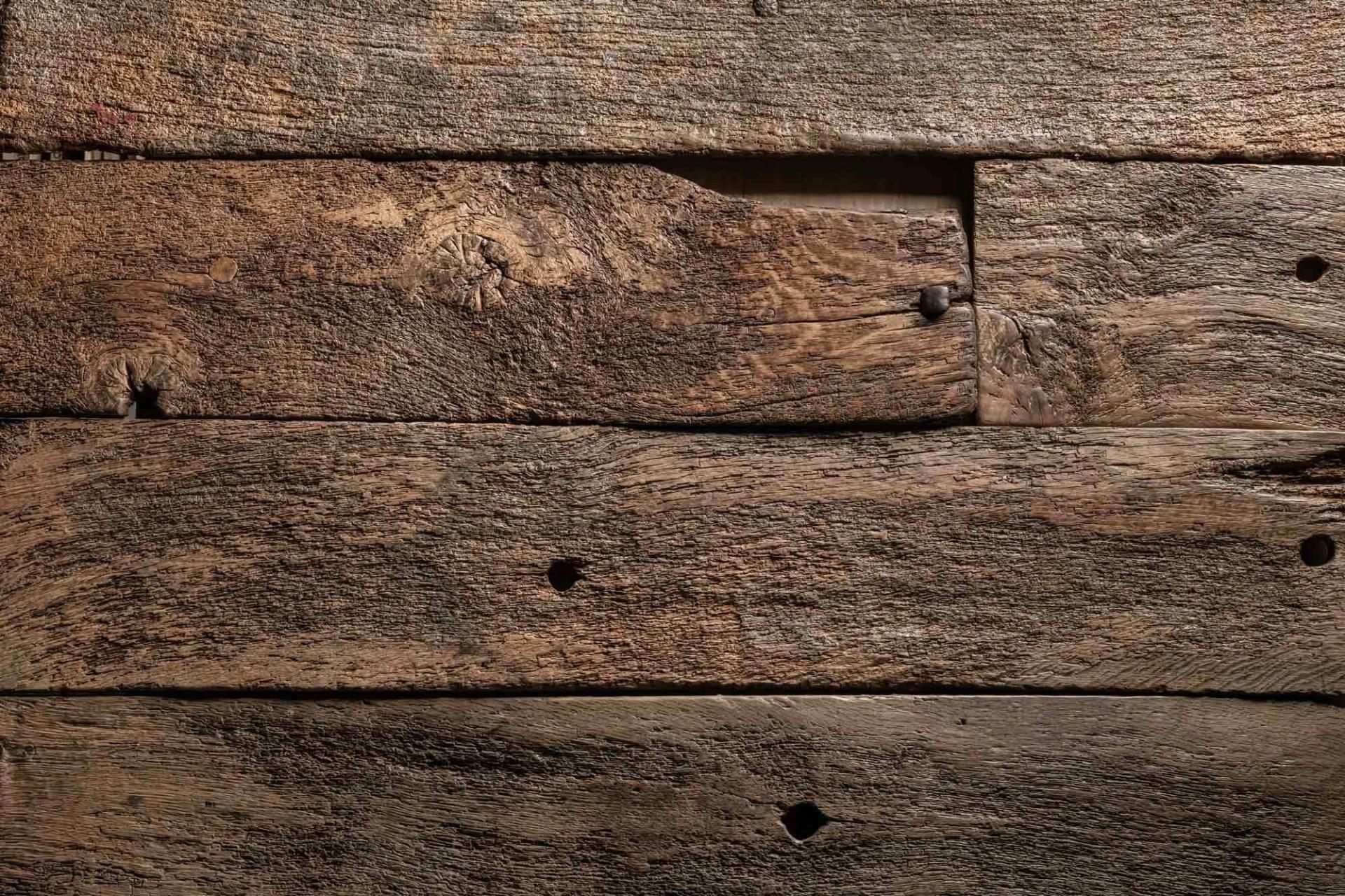 Reclaimed oak boards with original nail holes and saw marks