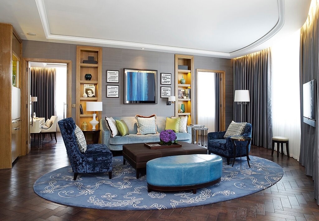 Living room sitting area, with blue toned furniture in a large spacious room.