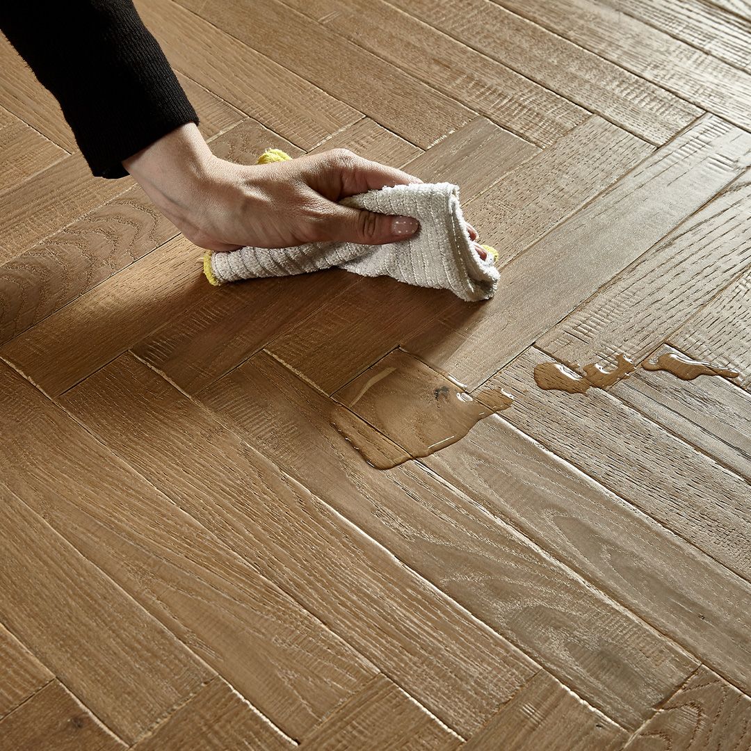 Someone wiping water from the floor
