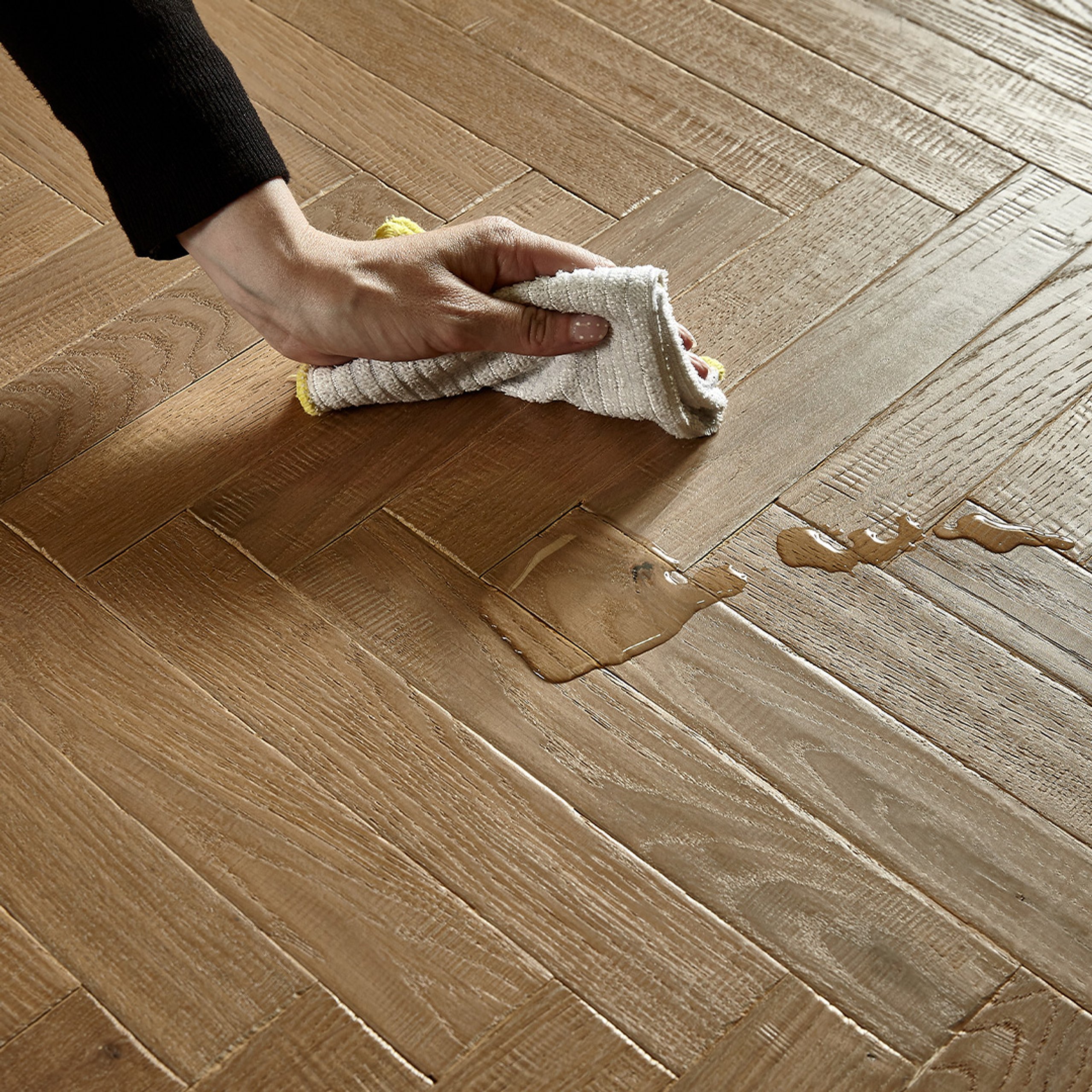 Someone wiping water from the floor